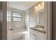Bright bathroom featuring marble tile, white fixtures, and a granite vanity at 2558 12Th S Ave, St Petersburg, FL 33712