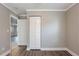 Empty bedroom with white closet doors, wood-look flooring, and gray walls at 2558 12Th S Ave, St Petersburg, FL 33712