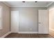 Empty bedroom with gray walls, wood-look floors, closet, and open door at 2558 12Th S Ave, St Petersburg, FL 33712