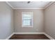 Empty bedroom with gray walls, dark wood-look floor, and a single window at 2558 12Th S Ave, St Petersburg, FL 33712