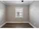 Empty bedroom with gray walls, dark wood-look floors, and a single window at 2558 12Th S Ave, St Petersburg, FL 33712