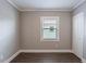Empty bedroom with gray walls, dark wood-look floors, a window, and closet at 2558 12Th S Ave, St Petersburg, FL 33712