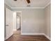 Empty bedroom with an open door leading to another room, gray walls, and wood-look floors at 2558 12Th S Ave, St Petersburg, FL 33712