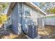 Exterior view of a gray house with white trim and an outdoor AC unit at 2558 12Th S Ave, St Petersburg, FL 33712