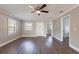 Bright living room with wood-look flooring, a ceiling fan, and an open floor plan at 2558 12Th S Ave, St Petersburg, FL 33712