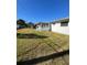 Spacious backyard with green lawn and white house exterior at 5770 46Th N Ave, Kenneth City, FL 33709