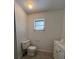 Clean bathroom with toilet, sink, and small window at 5770 46Th N Ave, Kenneth City, FL 33709