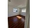Spacious bedroom with wood-look flooring and ample natural light at 5770 46Th N Ave, Kenneth City, FL 33709