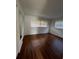 Large bedroom featuring wood-look flooring, white walls, and multiple windows at 5770 46Th N Ave, Kenneth City, FL 33709