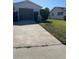 Concrete driveway leading to attached one-car garage at 5770 46Th N Ave, Kenneth City, FL 33709