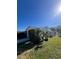 Side view of the single-story home with a fenced backyard and landscaping at 5770 46Th N Ave, Kenneth City, FL 33709