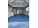 One-car garage interior with laundry area, storage, and painted floor at 5770 46Th N Ave, Kenneth City, FL 33709