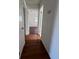 Hallway with wood-look flooring leading to bedrooms and bathroom at 5770 46Th N Ave, Kenneth City, FL 33709