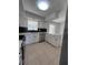 Remodeled kitchen with white shaker cabinets, black tile backsplash, stainless steel appliances, and white quartz countertops at 5770 46Th N Ave, Kenneth City, FL 33709