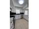 View of the kitchen highlighting white cabinets, black backsplash, stainless steel appliances, and ample counter space at 5770 46Th N Ave, Kenneth City, FL 33709