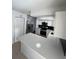 Updated kitchen with white shaker cabinets, contrasting black backsplash, stainless steel appliances, and a white countertop at 5770 46Th N Ave, Kenneth City, FL 33709