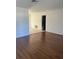 Empty living room with wood-look flooring and adjacent dining area at 5770 46Th N Ave, Kenneth City, FL 33709