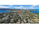 Aerial view of a neighborhood with houses, trees, water, and a city skyline at 753 37Th S Ave, St Petersburg, FL 33705