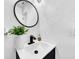 Powder room with modern vanity, stylish mirror, and textured walls at 753 37Th S Ave, St Petersburg, FL 33705