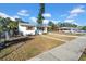 White home with teal door and carport, situated on a corner lot at 753 37Th S Ave, St Petersburg, FL 33705