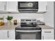 Modern kitchen with stainless steel appliances and white cabinets at 753 37Th S Ave, St Petersburg, FL 33705