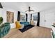 Cozy living room with plush teal couch, white walls, and wood-look flooring at 753 37Th S Ave, St Petersburg, FL 33705