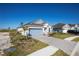 Single-story home with a blue garage, paved driveway, and landscaping at 25539 Calusa Dr, Punta Gorda, FL 33955