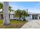 Front exterior view of a single-story home with teal shutters and a carport at 4532 103Rd W St, Bradenton, FL 34210