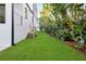 Spacious backyard with a lush green lawn and mature trees at 1046 Snell Isle Ne Blvd, St Petersburg, FL 33704