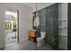 Stylish bathroom with green tile, walk-in shower, and access to a private balcony at 1046 Snell Isle Ne Blvd, St Petersburg, FL 33704