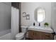 Modern bathroom with tiled shower, oval mirror, and wood vanity at 1046 Snell Isle Ne Blvd, St Petersburg, FL 33704