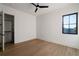 Empty bedroom with wood-look floors, a ceiling fan, and large window at 1046 Snell Isle Ne Blvd, St Petersburg, FL 33704