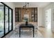 Stylish dining room featuring a black table, modern light fixture, and built-in cabinetry at 1046 Snell Isle Ne Blvd, St Petersburg, FL 33704