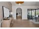 Inviting entryway with an arched doorway, wood flooring, and modern decor at 1046 Snell Isle Ne Blvd, St Petersburg, FL 33704