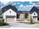 This modern home boasts a striking combination of brick, white siding, and a black metal roof, complemented by a neat lawn at 1046 Snell Isle Ne Blvd, St Petersburg, FL 33704