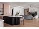 Kitchen and living area with modern fireplace, wood floors, and ceiling fan at 1046 Snell Isle Ne Blvd, St Petersburg, FL 33704