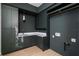 Modern laundry room with dark green cabinets, marble countertop, and gold hardware at 1046 Snell Isle Ne Blvd, St Petersburg, FL 33704
