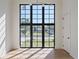 Bright and airy living space with large windows, wood floors, and a white door at 1046 Snell Isle Ne Blvd, St Petersburg, FL 33704