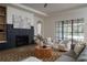 Cozy living room with a fireplace, large windows, and comfortable furniture at 1046 Snell Isle Ne Blvd, St Petersburg, FL 33704