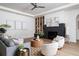 Living room with a fireplace, built-in shelves, large windows, and a ceiling fan at 1046 Snell Isle Ne Blvd, St Petersburg, FL 33704