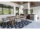 Covered outdoor kitchen with dining table, grill, and stylish area rug at 1046 Snell Isle Ne Blvd, St Petersburg, FL 33704