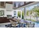 Outdoor kitchen and dining area with wood ceiling, grill, and pool view at 1046 Snell Isle Ne Blvd, St Petersburg, FL 33704