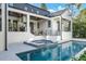 Inviting pool and spa with a waterfall feature and outdoor kitchen at 1046 Snell Isle Ne Blvd, St Petersburg, FL 33704