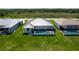 Aerial view of a home featuring a screened-in pool and green lawn at 243 Rotonda S Blvd, Rotonda West, FL 33947