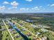 Stunning aerial view showcasing a canal-front property in a picturesque community with lush greenery at 243 Rotonda S Blvd, Rotonda West, FL 33947