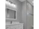 Modern bathroom with white vanity, large mirror, and tiled shower at 243 Rotonda S Blvd, Rotonda West, FL 33947