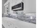 Modern white kitchen with stainless steel appliances and sleek countertops at 243 Rotonda S Blvd, Rotonda West, FL 33947