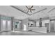 Open-concept living and kitchen area with high ceilings and modern light fixtures at 243 Rotonda S Blvd, Rotonda West, FL 33947