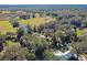 Scenic aerial view of a rural property with a house, pond, and trees at 2707 De Montmollin Rd, Plant City, FL 33565