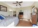 Bedroom with ceiling fan, wooden furniture, and a TV at 2707 De Montmollin Rd, Plant City, FL 33565